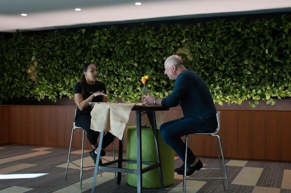 Mark and Bridgette speaking at a table.